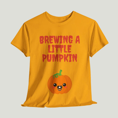 Gold t-shirt featuring red text "Brewing A Little Pumpkin," perfect for announcing a pregnancy during Halloween, worn by a smiling woman.