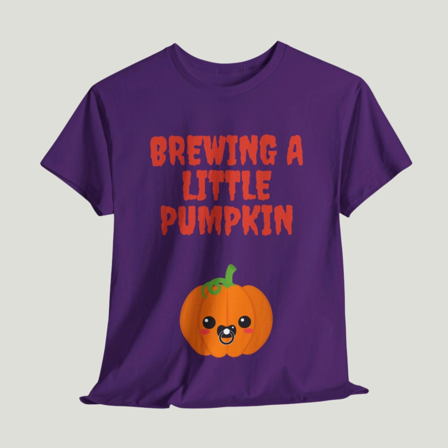 Purple  t-shirt featuring red text "Brewing A Little Pumpkin," perfect for announcing a pregnancy during Halloween, worn by a smiling woman.