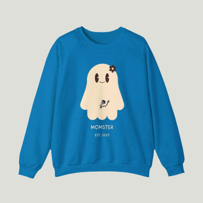 Cute Ghost Momster Sweatshirt in sapphire color featuring an adorable illustration of a ghost with a skeleton holding a pacifier, waving from the belly. The design includes the text “Momster. Established 2025,” making it an ideal choice for announcing a pregnancy during Halloween celebrations. Perfect for a fun and festive reveal!