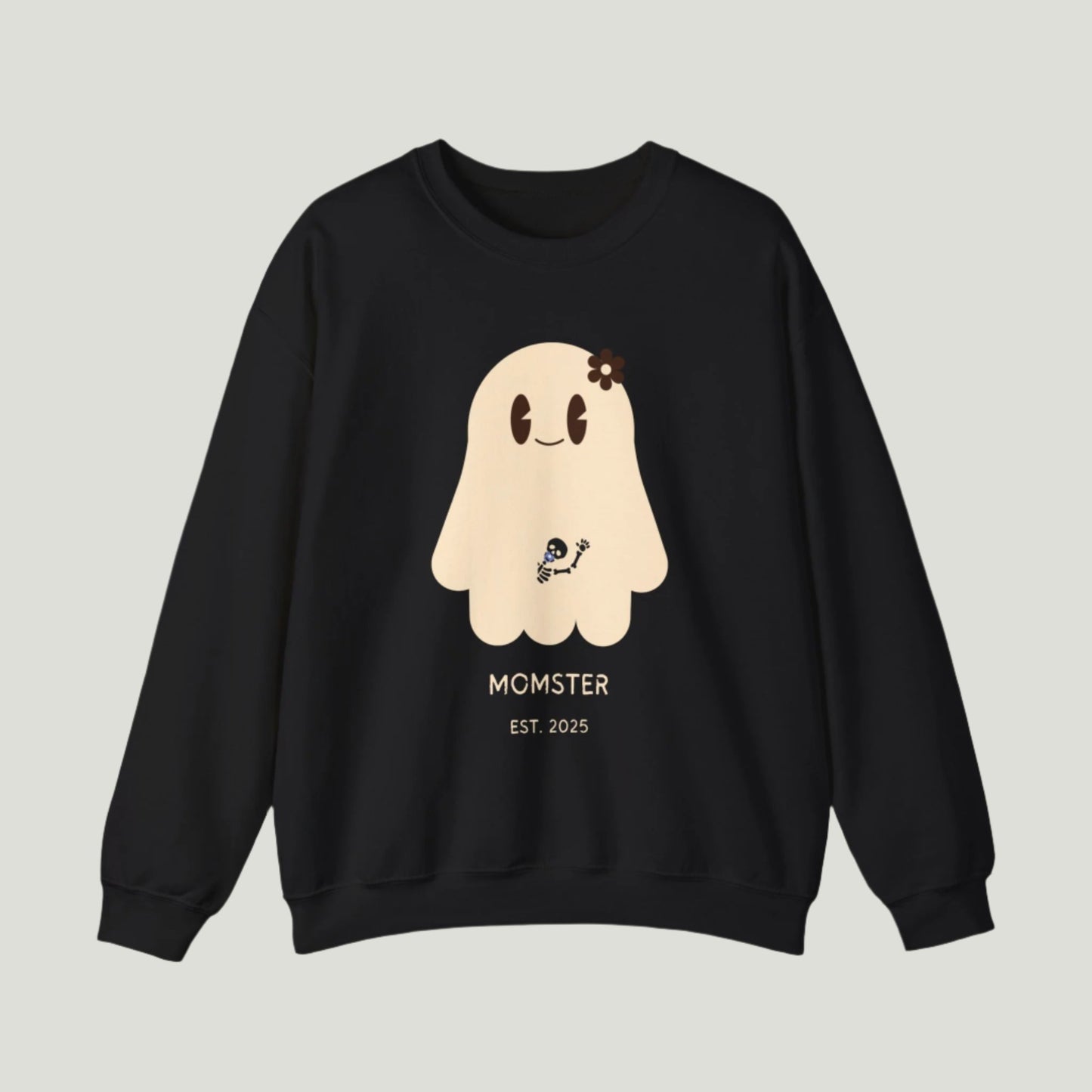 Cute Ghost Momster Sweatshirt in black color featuring an adorable illustration of a ghost with a skeleton holding a pacifier, waving from the belly. The design includes the text “Momster. Established 2025,” making it an ideal choice for announcing a pregnancy during Halloween celebrations. Perfect for a fun and festive reveal!