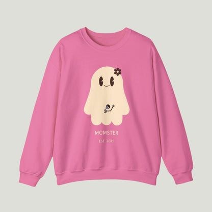 Cute Ghost Momster Sweatshirt in safety pink color featuring an adorable illustration of a ghost with a skeleton holding a pacifier, waving from the belly. The design includes the text “Momster. Established 2025,” making it an ideal choice for announcing a pregnancy during Halloween celebrations. Perfect for a fun and festive reveal!