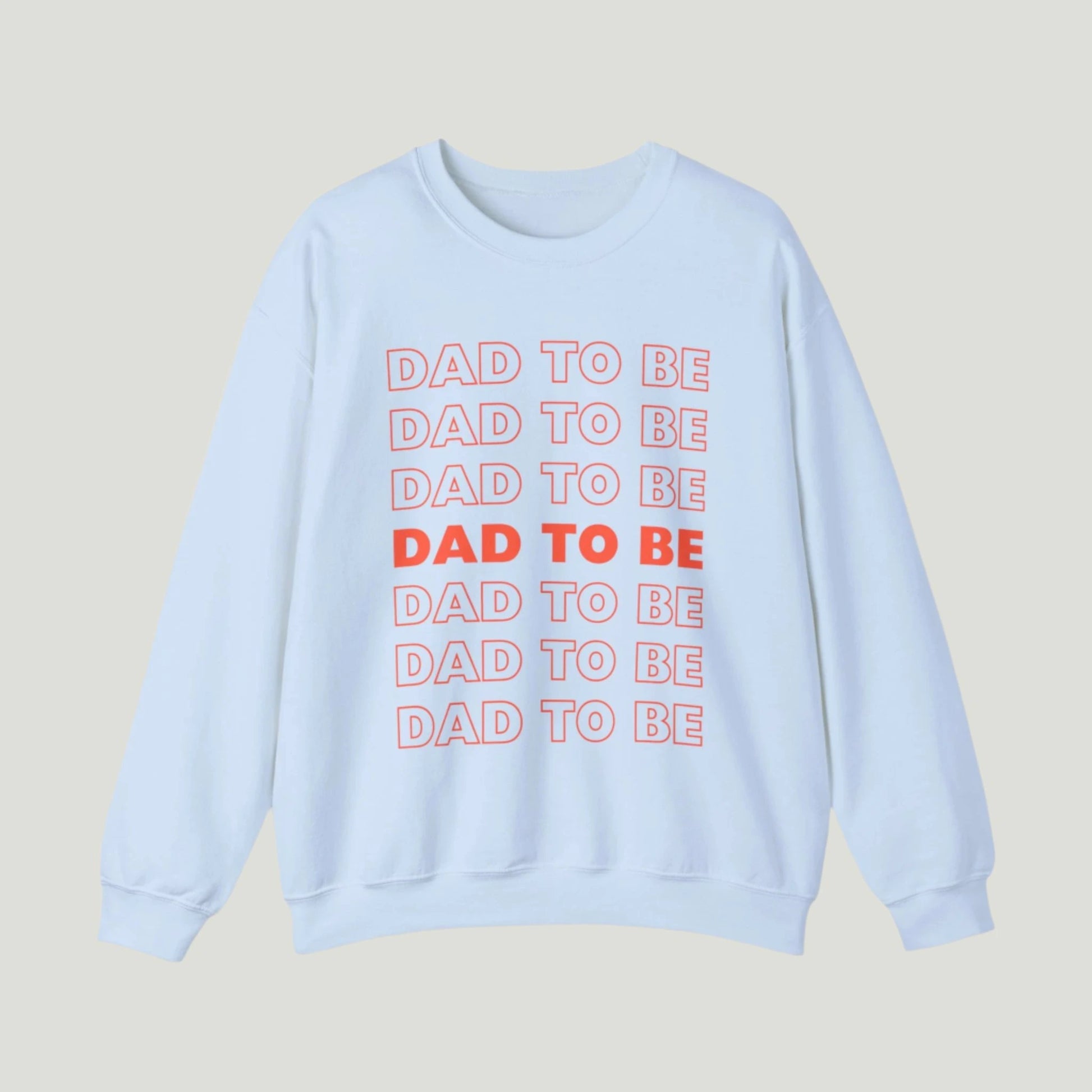 Light Blue Dad To Be Sweatshirt featuring bold orange lettering with the phrase "Dad To Be" repeated multiple times. Ideal for announcing pregnancy to expectant fathers in a fun and stylish way. Perfect for celebrating this exciting journey!