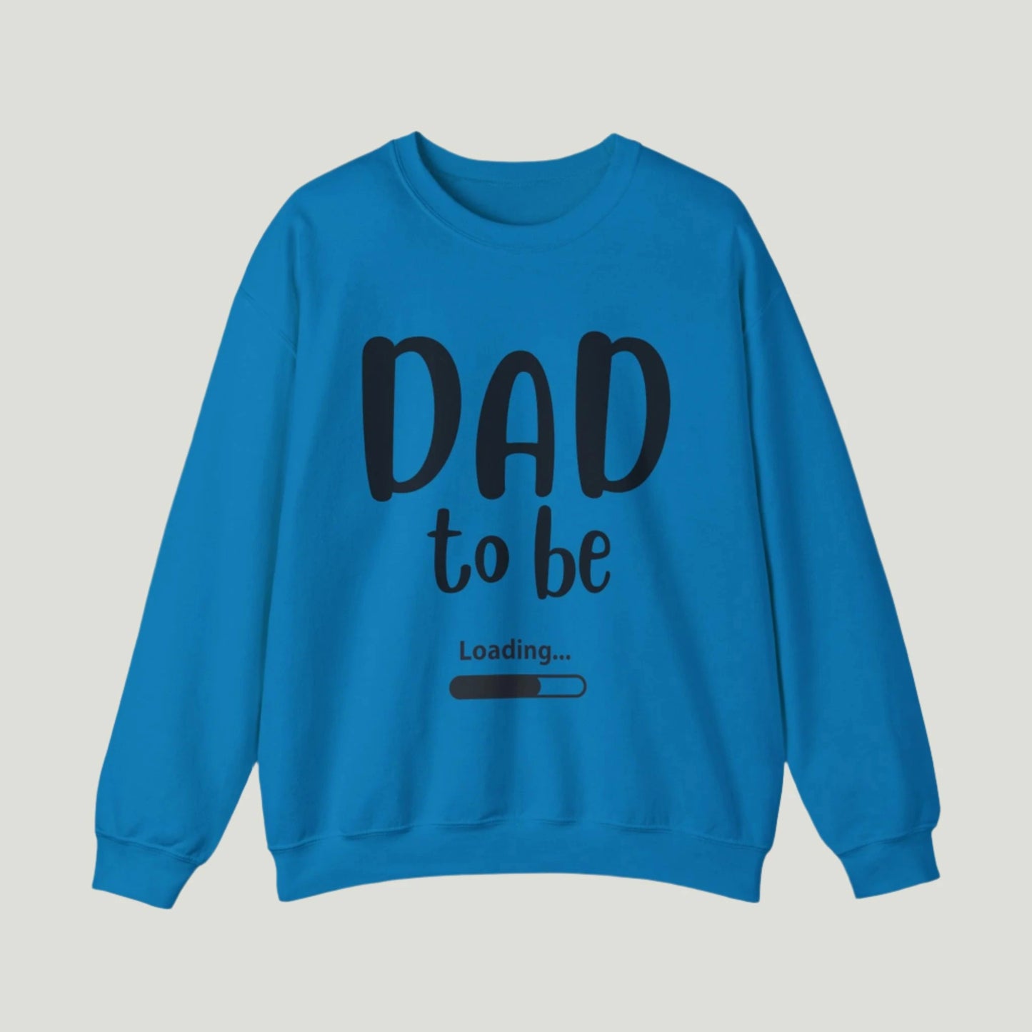 Blue-colored Dad To Be Loading Sweatshirt, perfect for announcing a pregnancy to expectant fathers. The design features playful loading text, capturing the excitement of becoming a dad. A cozy and stylish way to share the news!