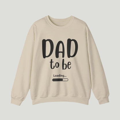 Sand-colored Dad To Be Loading Sweatshirt, perfect for announcing a pregnancy to expectant fathers. The design features playful loading text, capturing the excitement of becoming a dad. A cozy and stylish way to share the news!