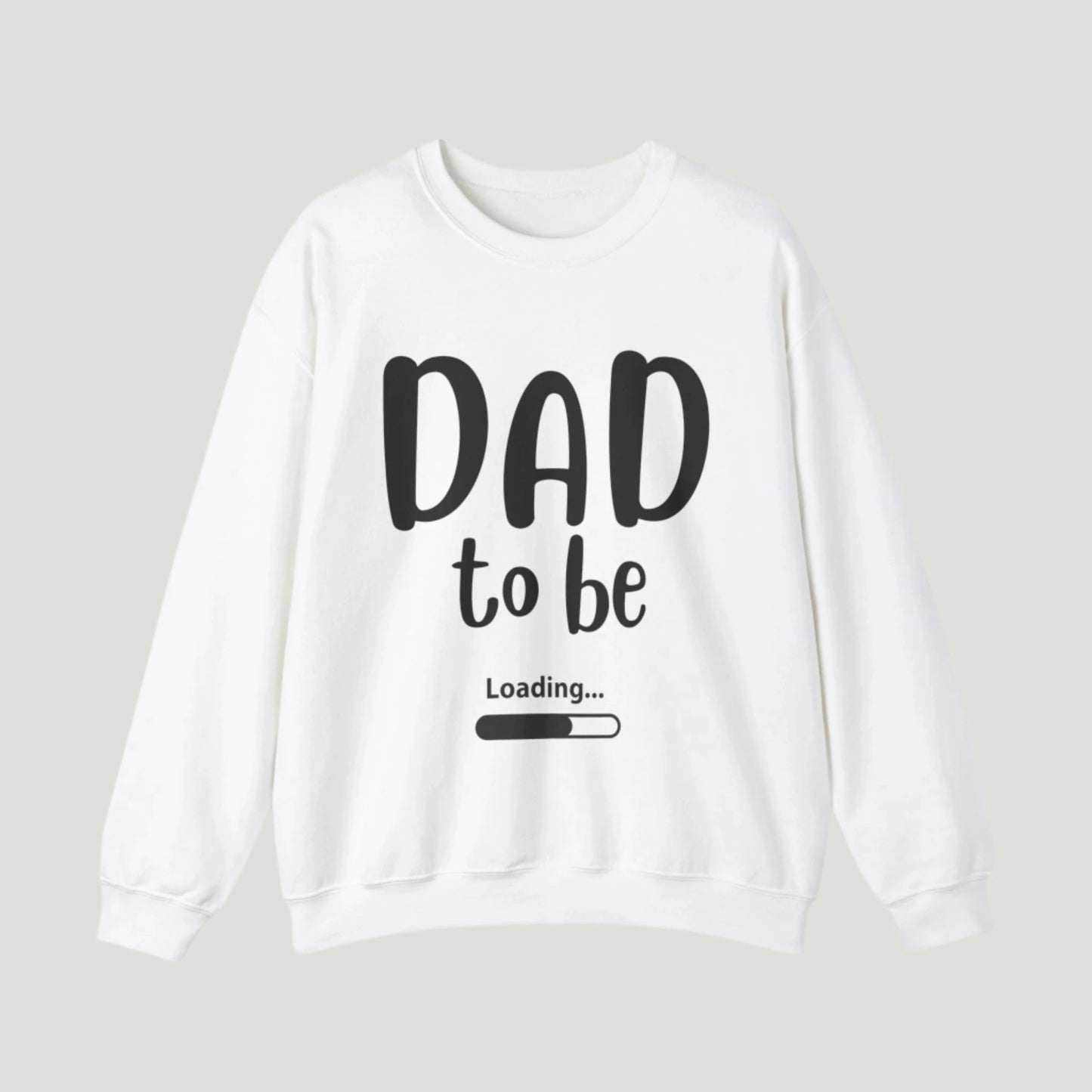 White-colored Dad To Be Loading Sweatshirt, perfect for announcing a pregnancy to expectant fathers. The design features playful loading text, capturing the excitement of becoming a dad. A cozy and stylish way to share the news!