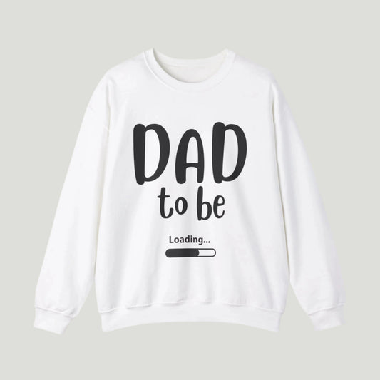 White-colored Dad To Be Loading Sweatshirt, perfect for announcing a pregnancy to expectant fathers. The design features playful loading text, capturing the excitement of becoming a dad. A cozy and stylish way to share the news!