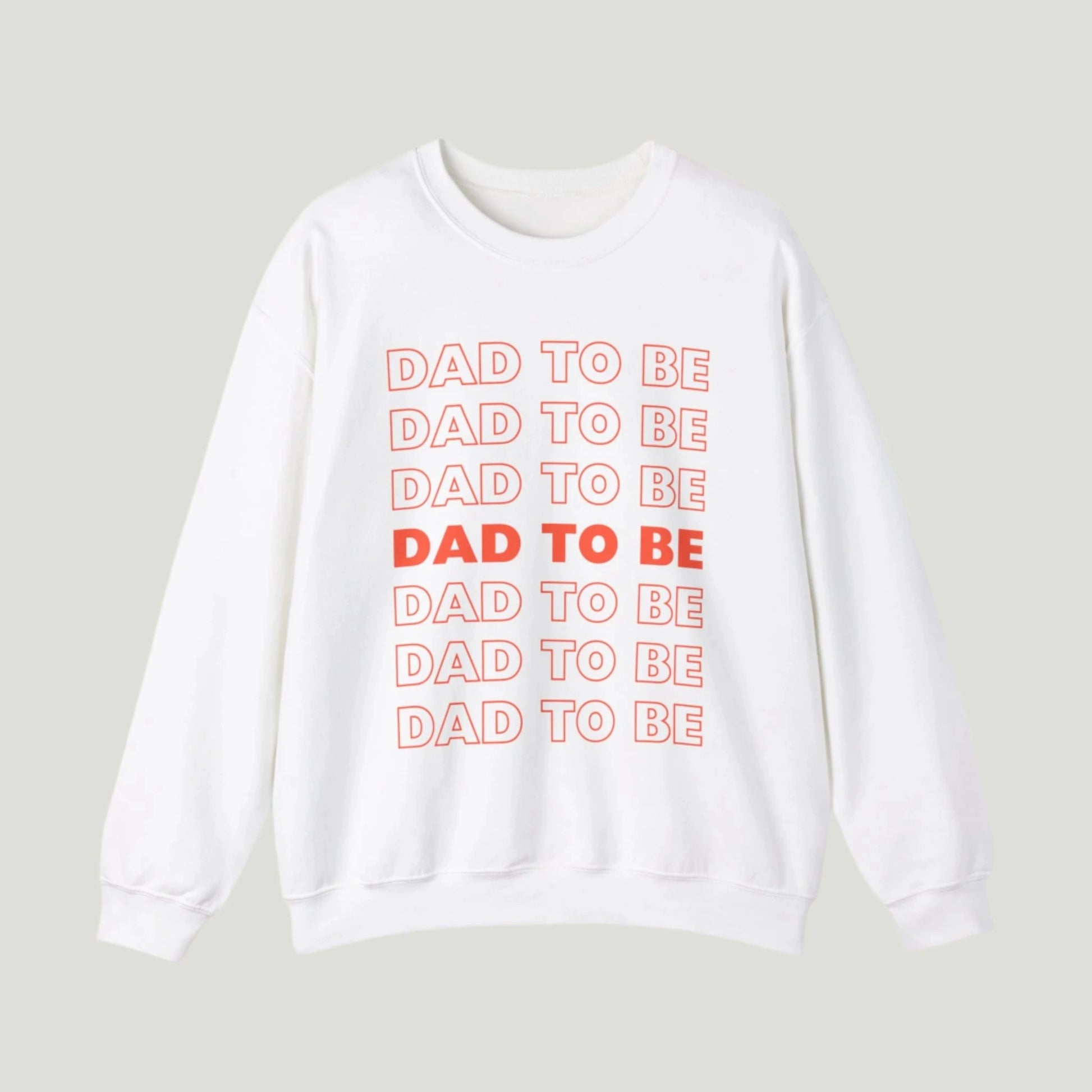 White Dad To Be Sweatshirt featuring bold orange lettering with the phrase "Dad To Be" repeated multiple times. Ideal for announcing pregnancy to expectant fathers in a fun and stylish way. Perfect for celebrating this exciting journey!