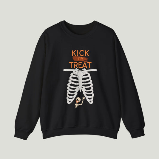 Black Kick or Treat Skeleton Sweatshirt showcasing the playful quote "Kick or Treat" alongside an illustration of a skeleton with a tiny skeleton holding a pacifier in the belly area. Perfect for announcing a pregnancy during Halloween, this cozy sweatshirt adds a festive touch to the joyous news!