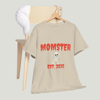 Sand t-shirt featuring red text "Momster Est. 2025," perfect for announcing a pregnancy during Halloween, showcasing a playful and festive design.