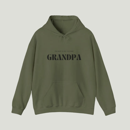 Green  sweatshirt with black text reading "The Best Is Yet To Come GRANDPA," perfect for announcing a pregnancy to soon-to-be grandparents.